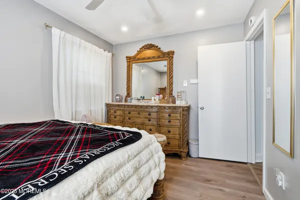 a bedroom with a bed and a mirror
