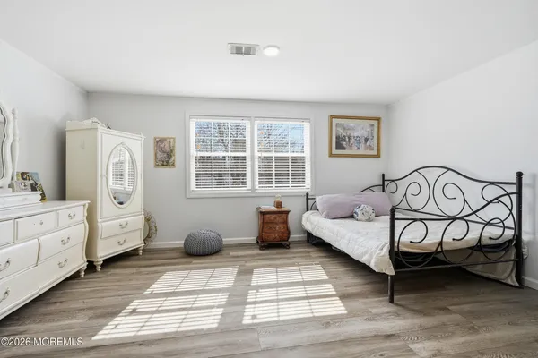 a bedroom with furniture and windows