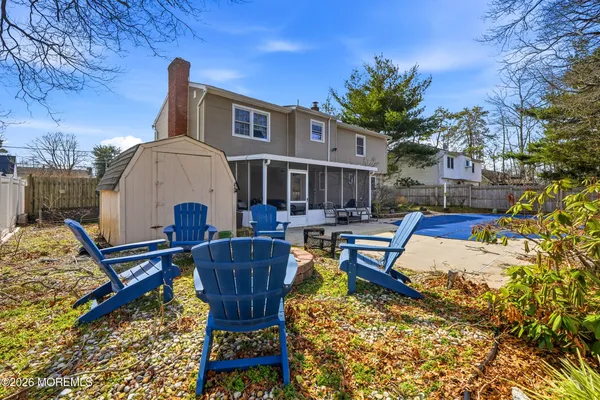 a view of backyard with a table and chairs