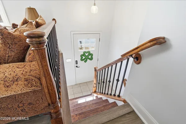 a view of a hallway with wooden floor and stairs