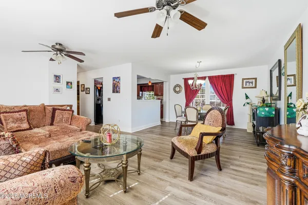 a living room with furniture and wooden floor