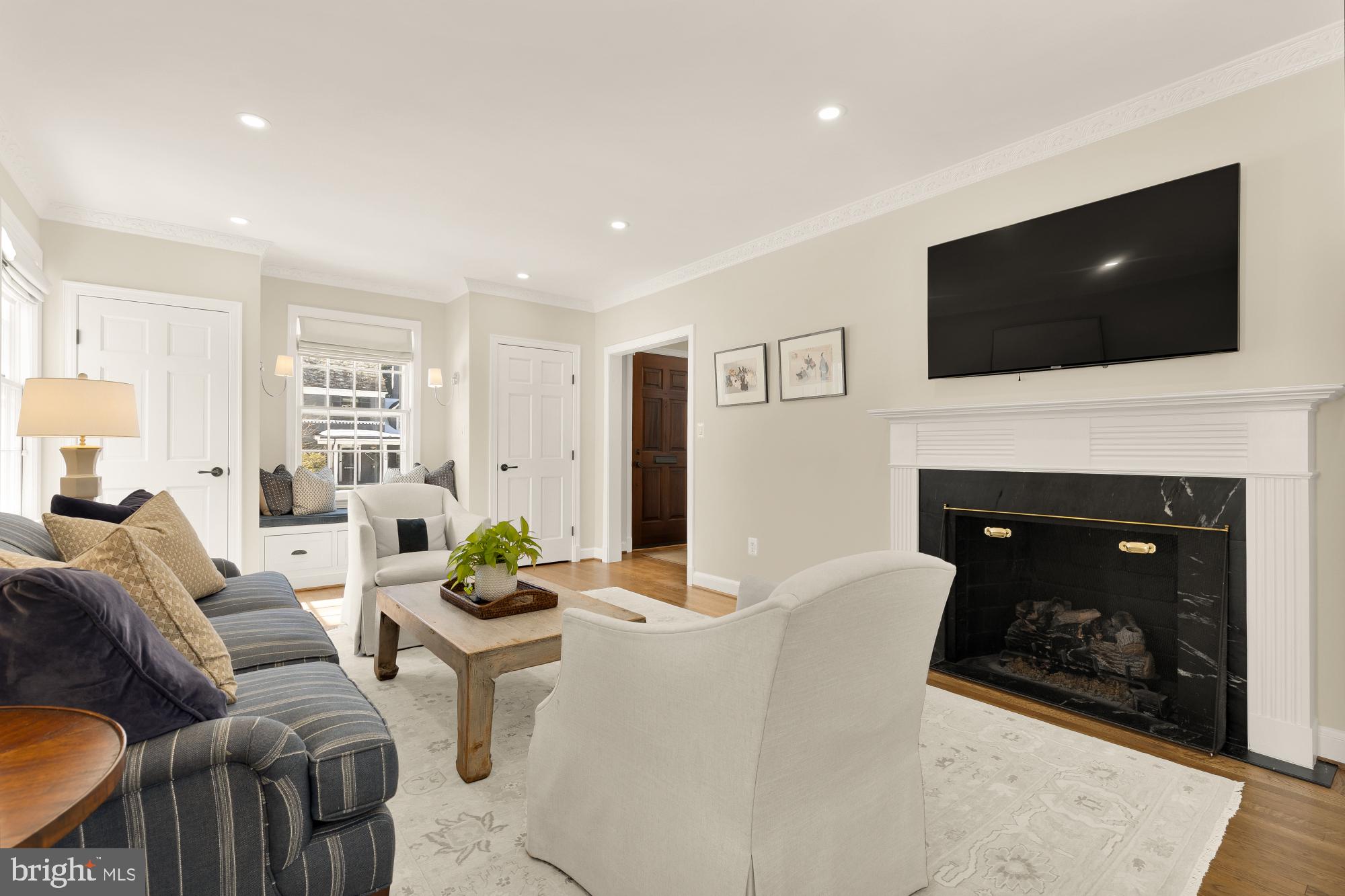 4501 47th Street Northwest Washington, DC 20016 - Photo 13 of 61 a living room with furniture a flat screen tv and a fireplace