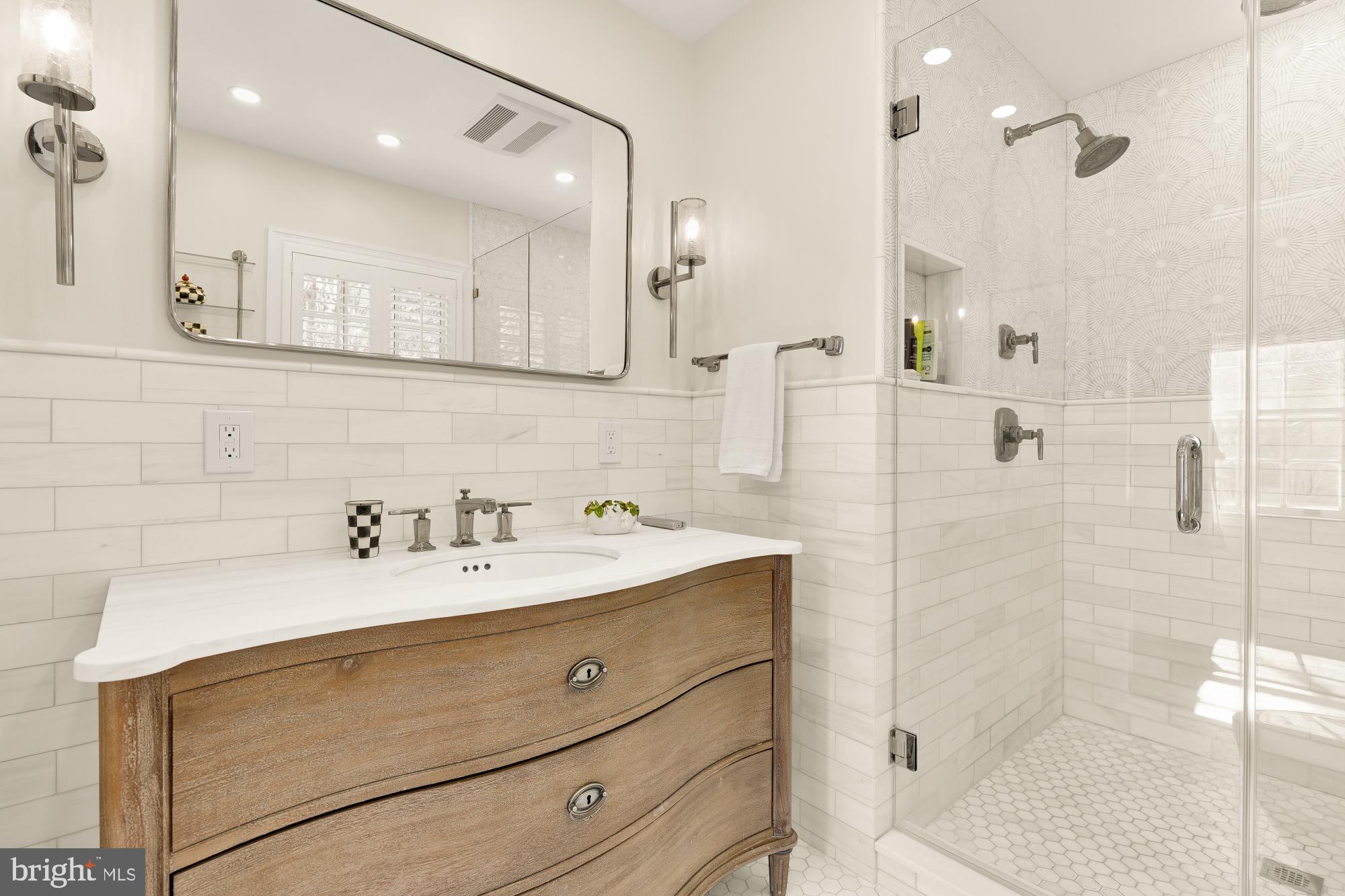 4501 47th Street Northwest Washington, DC 20016 - Photo 29 of 61 a bathroom with a sink a toilet a mirror and shower
