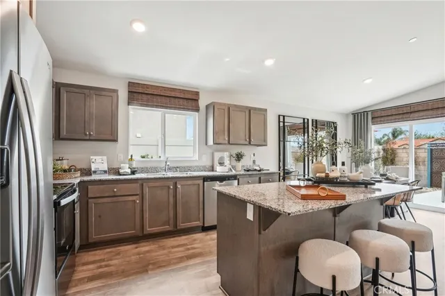a kitchen with granite countertop a sink and cabinets