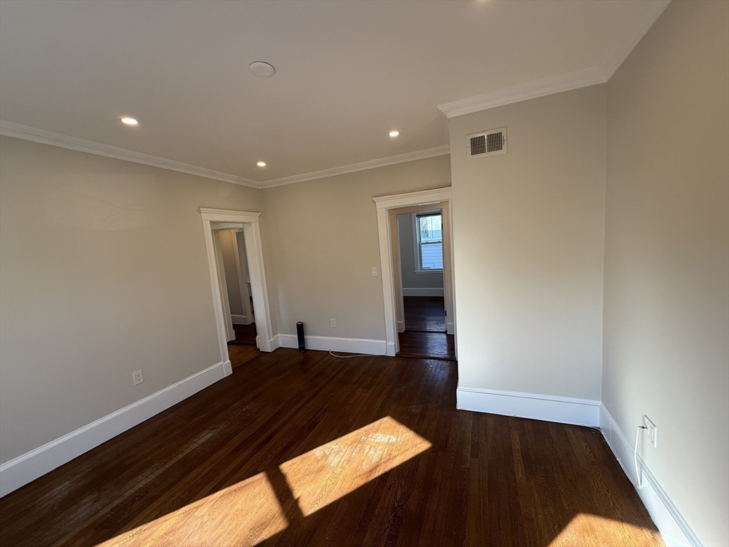 55 Iffley Road, Unit 3 Boston, MA 02130 - Photo 2 of 12 wooden floor in an empty room with a window