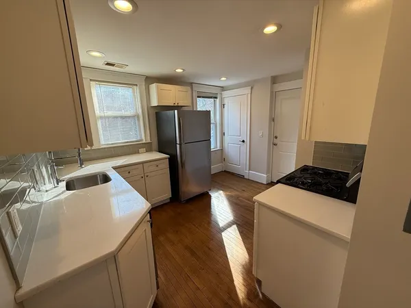 a kitchen with a refrigerator a stove and a sink