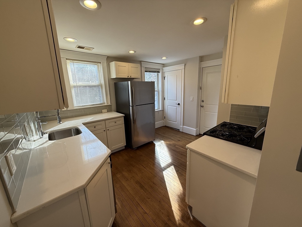 55 Iffley Road, Unit 3 Boston, MA 02130 - Photo 3 of 12 a kitchen with a refrigerator a stove and a sink