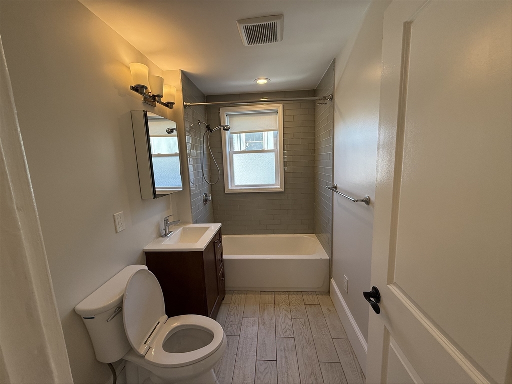55 Iffley Road, Unit 3 Boston, MA 02130 - Photo 5 of 12 a bathroom with a toilet sink and bathtub