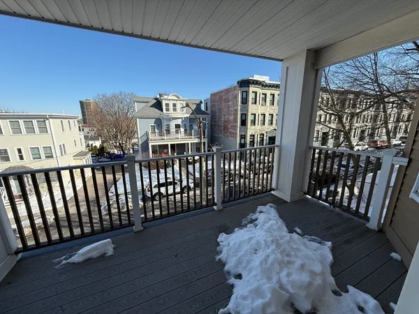 a view of a porch with wooden floor