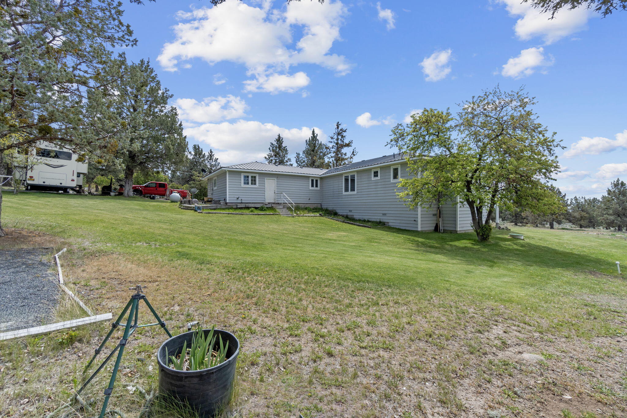 17722 Pope Road Merrill, OR 97633 - Photo 60 of 61 a view of a backyard with fountain plants and large trees