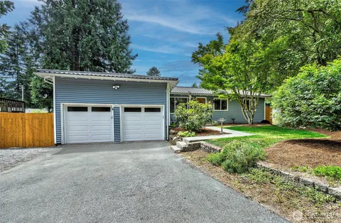 a view of a house with a yard and garage