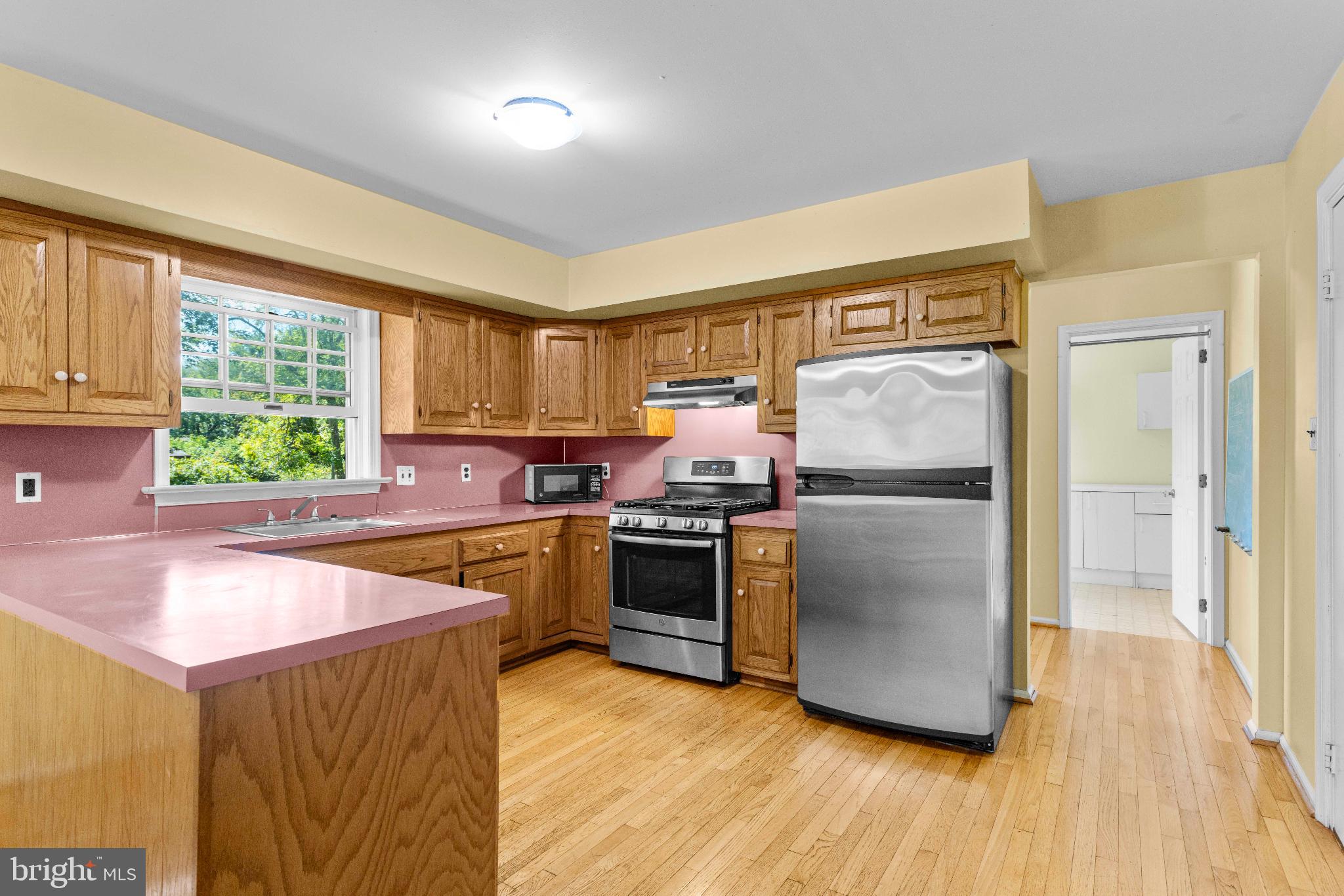 1478 Dillon Road Ambler, PA 19002 - Photo 11 of 42 a kitchen with stainless steel appliances granite countertop a refrigerator a sink dishwasher a stove and white countertops with wooden floor
