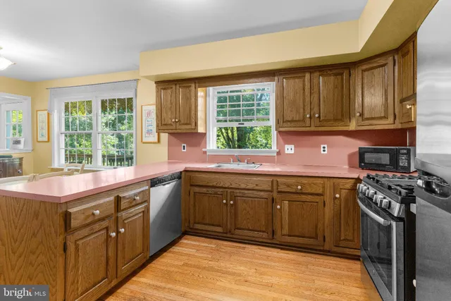 a kitchen with a sink stove top oven and cabinets