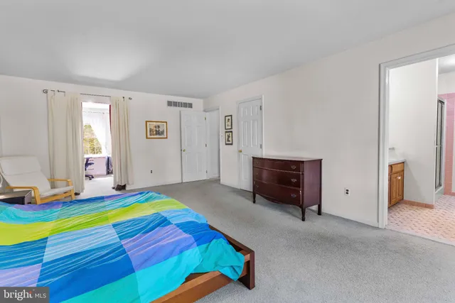 a room with a bed and a computer on the desk