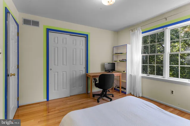 a workspace with wooden floor and a window