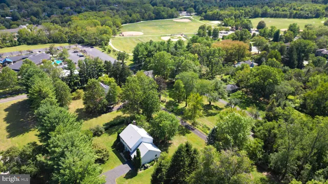 an aerial view of residential house with outdoor space and swimming pool