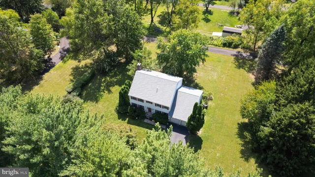 a view of a house with a yard and sitting area