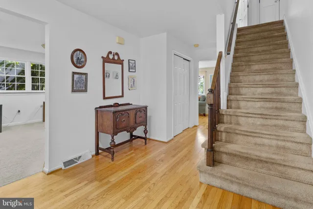 a view of a hallway with wooden floor and entryway