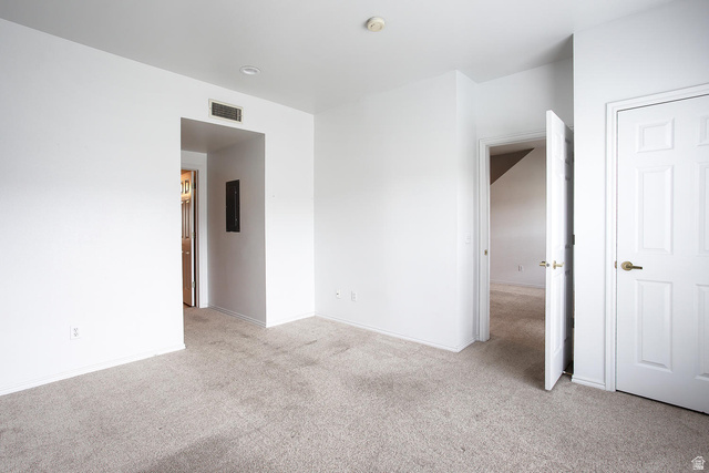 900 Bitner Road, Unit H35 Park City, UT 84098 - Photo 8 of 14 Spacious bedroom featuring neutral carpet flooring, white six-panel closet doors, and multiple entry points