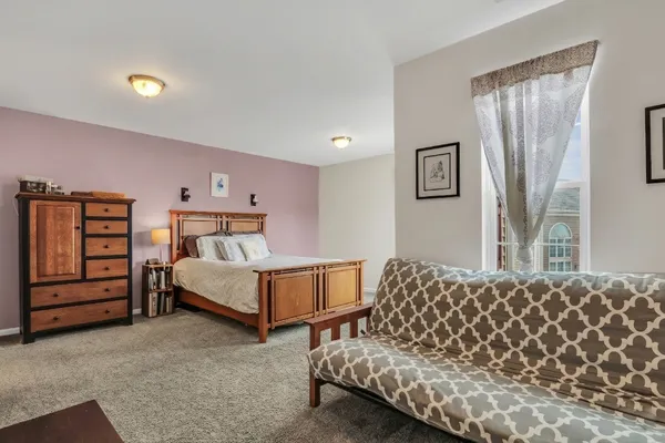 a bedroom with a bed and dresser