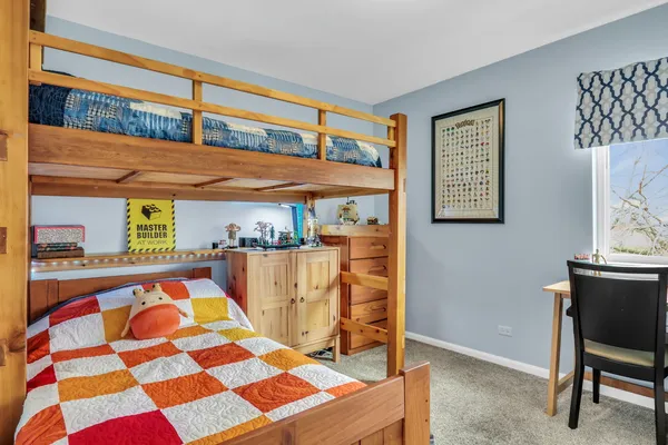 a bedroom with a bed and a table in it