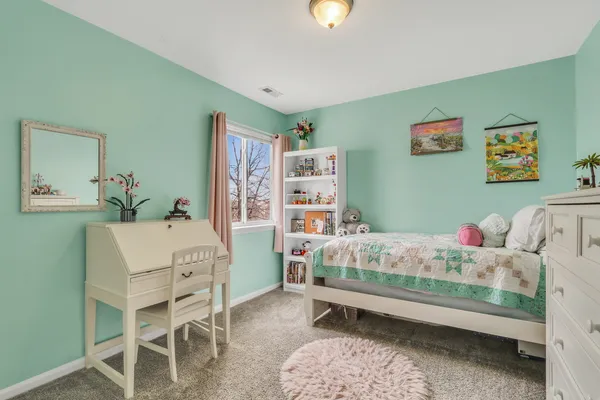 a bedroom with furniture and a wooden floor