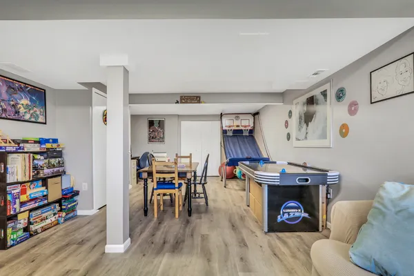a living room with furniture and a wooden floor
