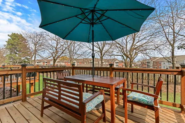 a view of a balcony with chairs and wooden floor
