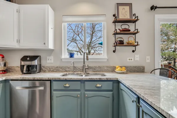 a kitchen with stainless steel appliances granite countertop a sink stove and cabinets