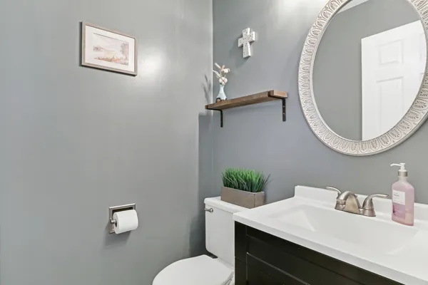 a bathroom with a sink mirror and toilet