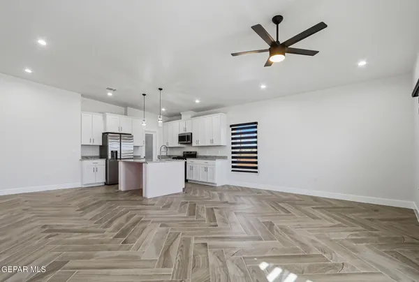an empty room with closet and a ceiling fan