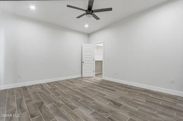 a view of a room with a ceiling fan and window