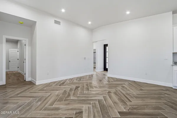 a view of a room that has a window and wooden floor