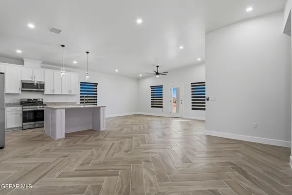 a kitchen with a refrigerator and microwave