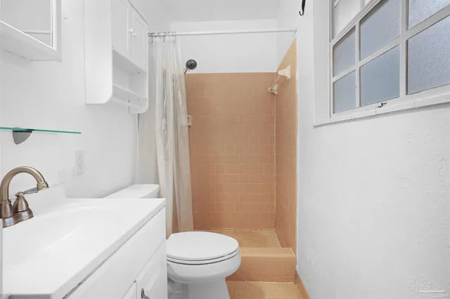 a bathroom with a sink toilet and shower