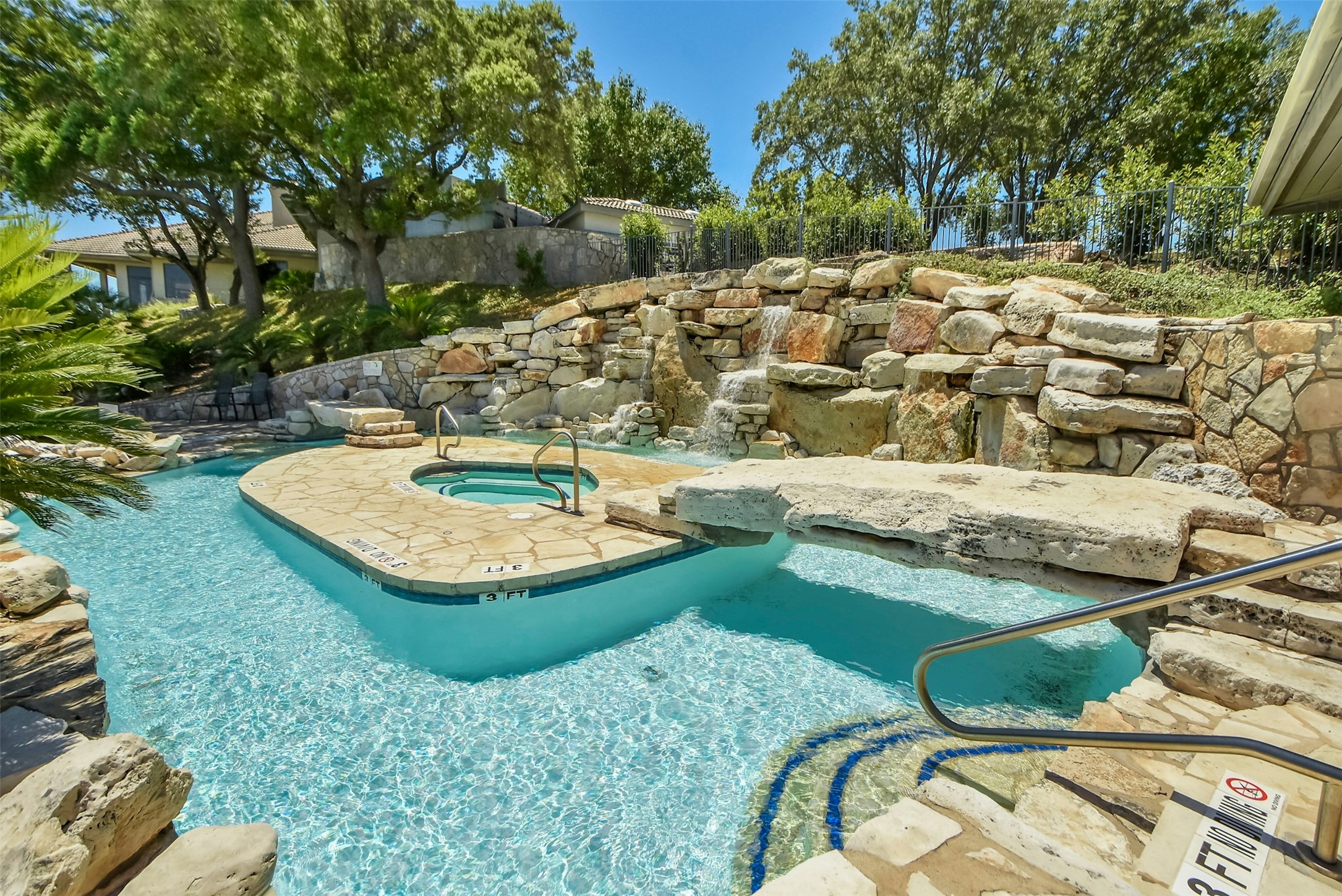 26710 Founders Place Spicewood, TX 78669 - Photo 17 of 19 a view of a swimming pool with a yard and large trees