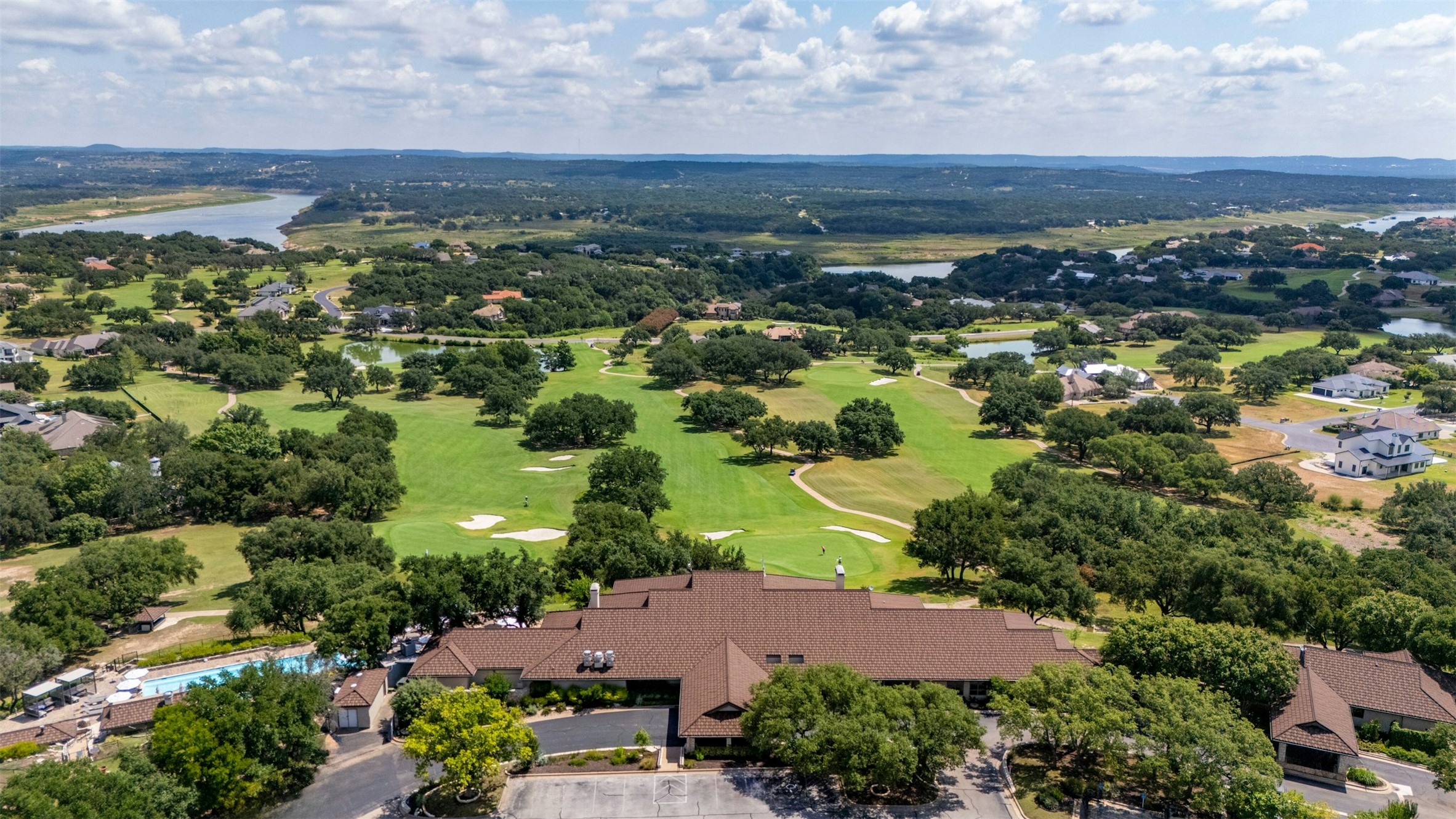 26710 Founders Place Spicewood, TX 78669 - Photo 18 of 19 an aerial view of residential houses with outdoor space and trees