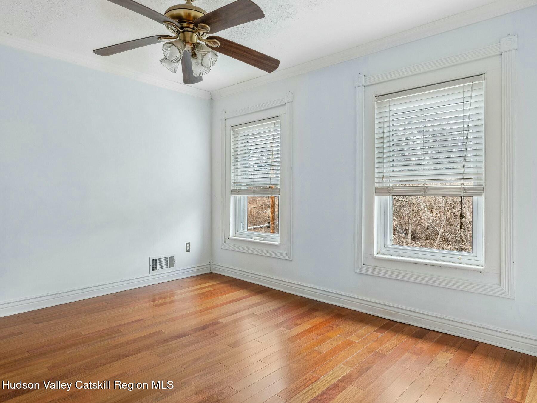 27 Brick Row Street Athens, NY 12015 - Photo 12 of 37 a view of an empty room with wooden floor and a window