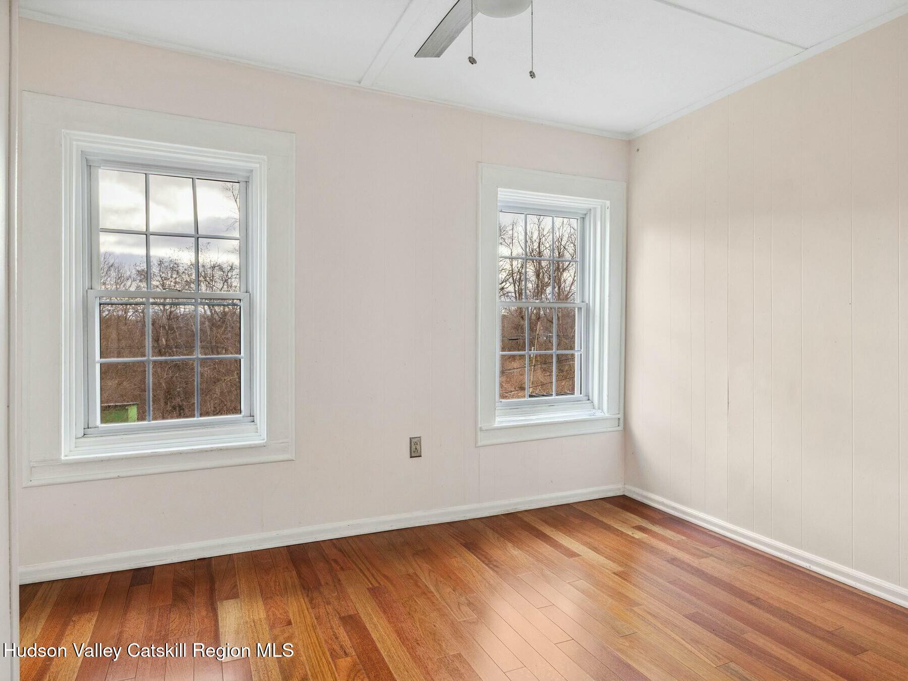 27 Brick Row Street Athens, NY 12015 - Photo 13 of 37 an empty room with wooden floor and windows