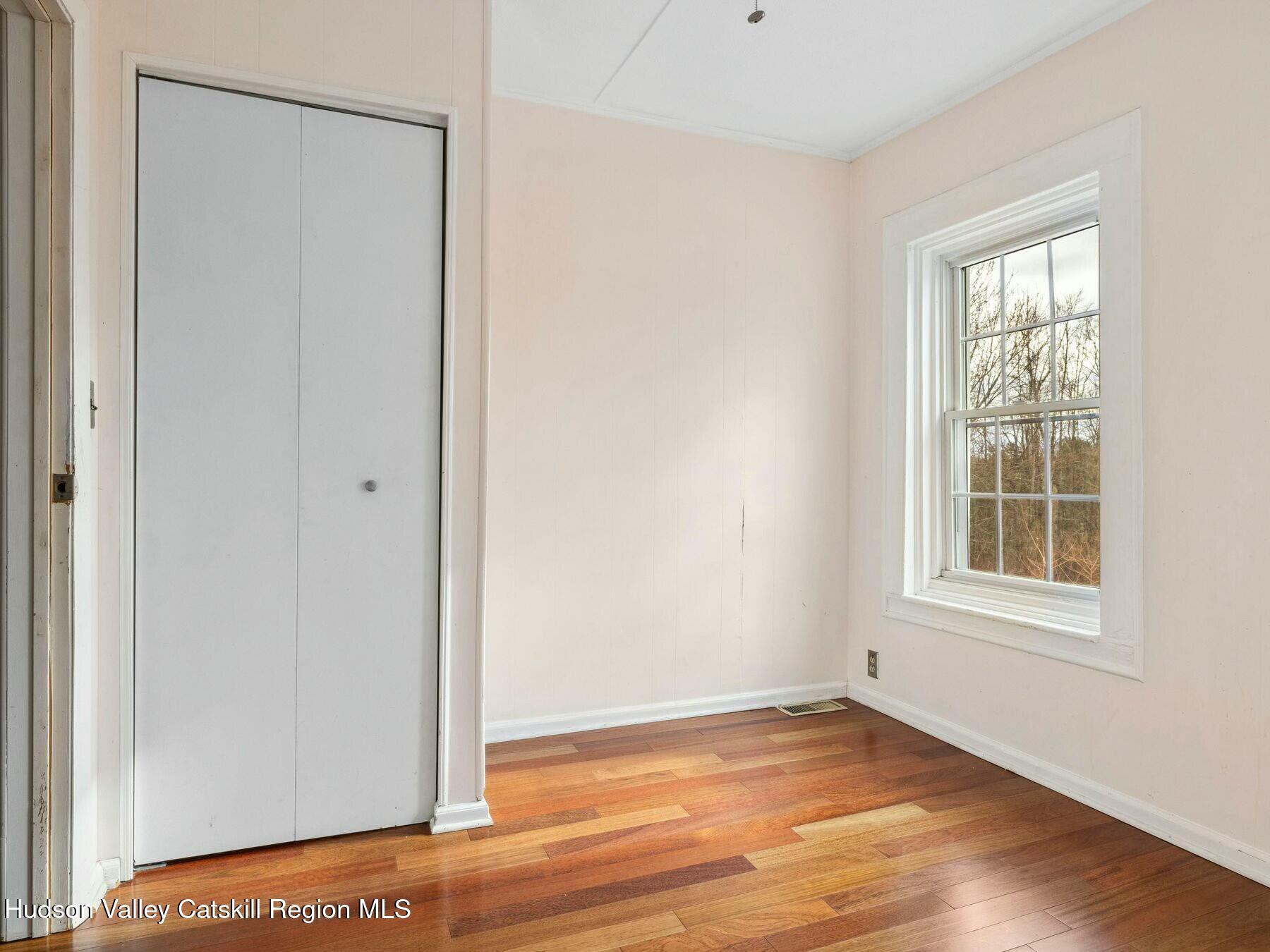 27 Brick Row Street Athens, NY 12015 - Photo 15 of 37 a view of an empty room with wooden floor and a window