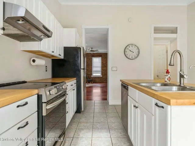 a kitchen with stainless steel appliances granite countertop a stove and a sink