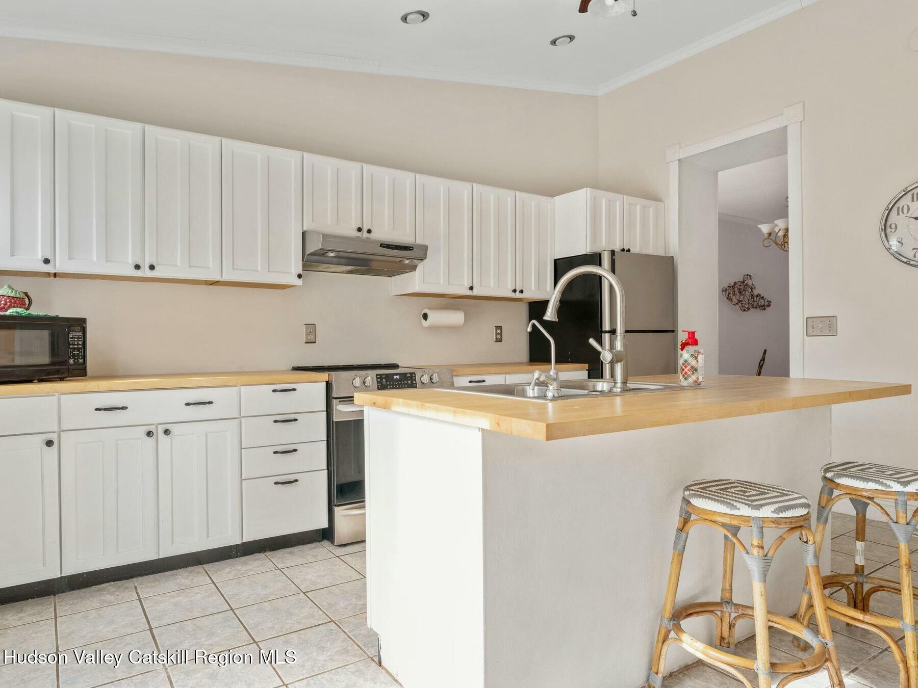 27 Brick Row Street Athens, NY 12015 - Photo 8 of 37 a kitchen with granite countertop a sink and a stove top oven