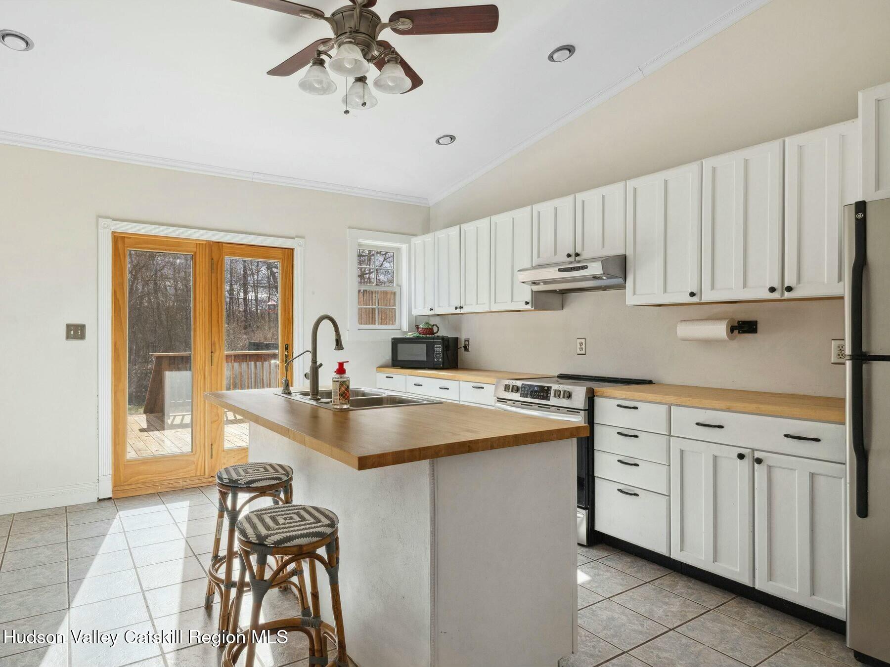 27 Brick Row Street Athens, NY 12015 - Photo 9 of 37 a kitchen with cabinets a sink and appliances