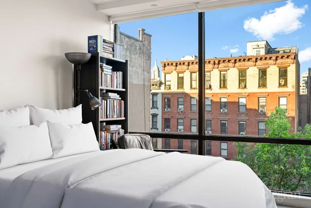 a spacious bedroom with a bed and window