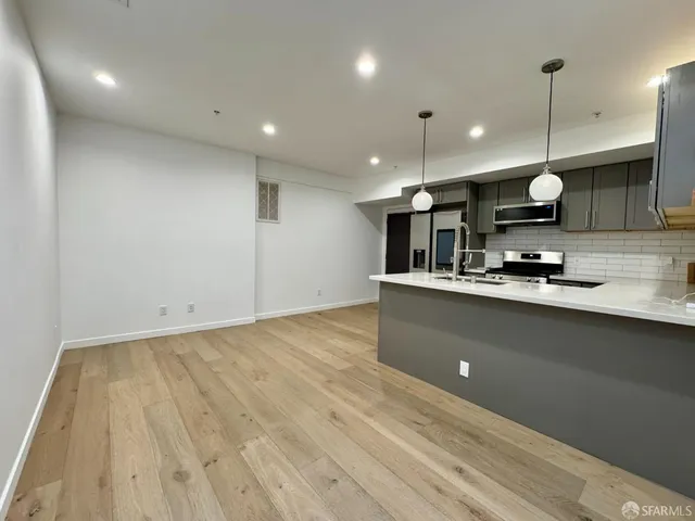a kitchen with kitchen island a counter top space a sink and appliances