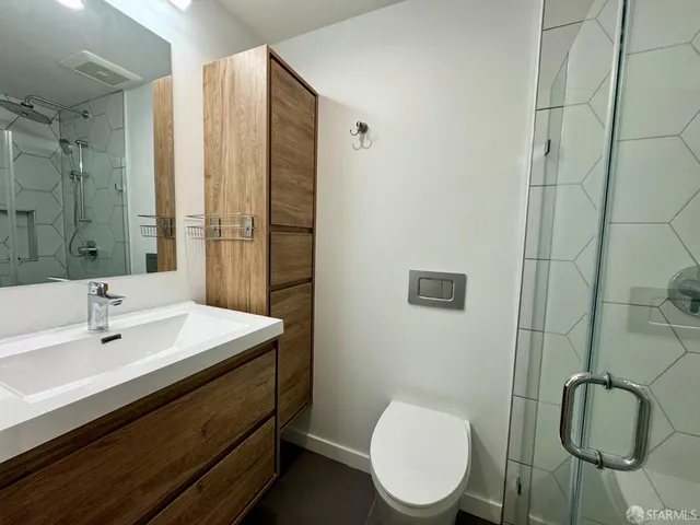 a bathroom with a toilet sink and mirror