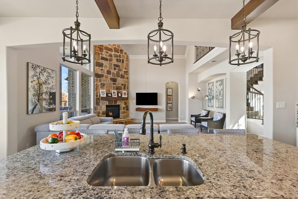 14006 Stars Road Frisco, TX 75035 - Photo 12 of 38 a kitchen with a sink a chandelier and living room view