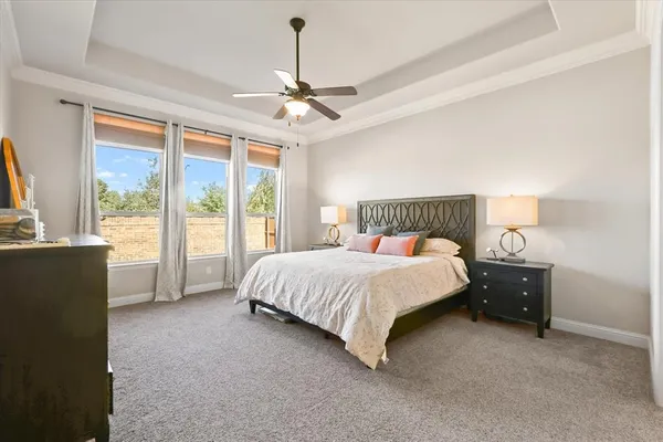 a spacious bedroom with a bed and window
