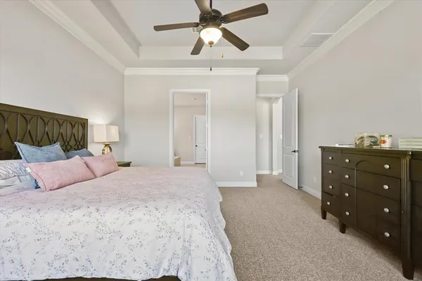 a bedroom with a bed and a ceiling fan