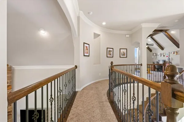 a view of staircase with railing and a chandelier